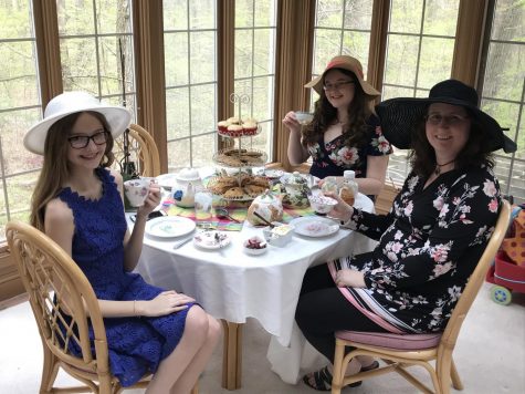 My family organized an elaborate tea party. In this photo, you can see our fancy table setting, outfits, and treats.