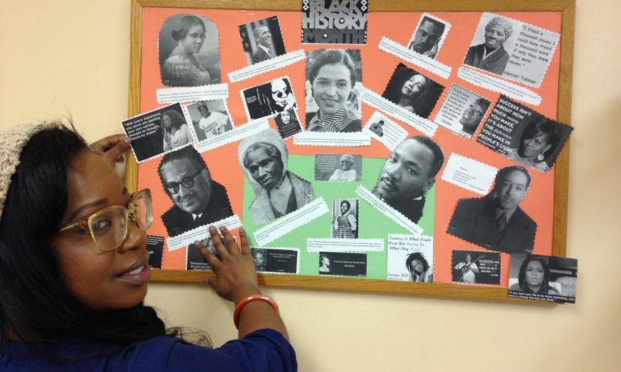 Maria H., an employee at NHS is pictured with a Black History Month collage that she created for a classroom activity. 