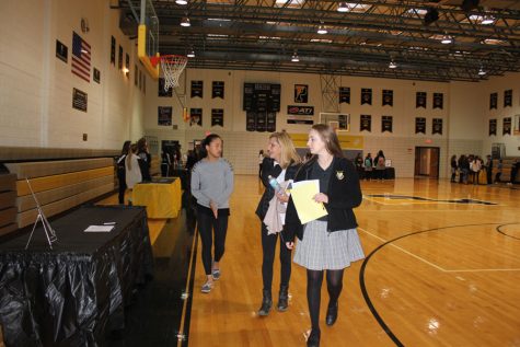Junior gives visitors a tour around the sports information section in the gym