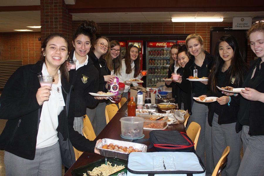 Italian II class holding up their food 