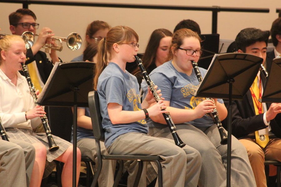 Clarinet players performing with the orchestra. 