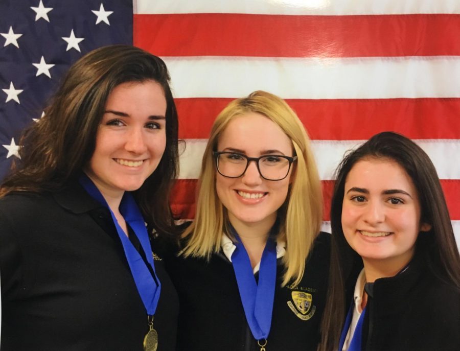 Natalie Onesi, Chrissy Molloy, and Sara Mayberry pose for a photo after they receive their first place medals.