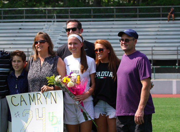 Camryn Scully and her family pose for a picture with their very own senior on senior night.