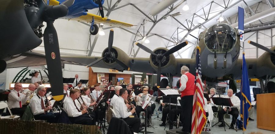 The Milford Community Band performs during the ceremony in the AMC Museum’s hangar. Two restored aircraft from World War II, a C-47 cargo lifter and a B-17 bomber, served as the backdrop for the day’s events.