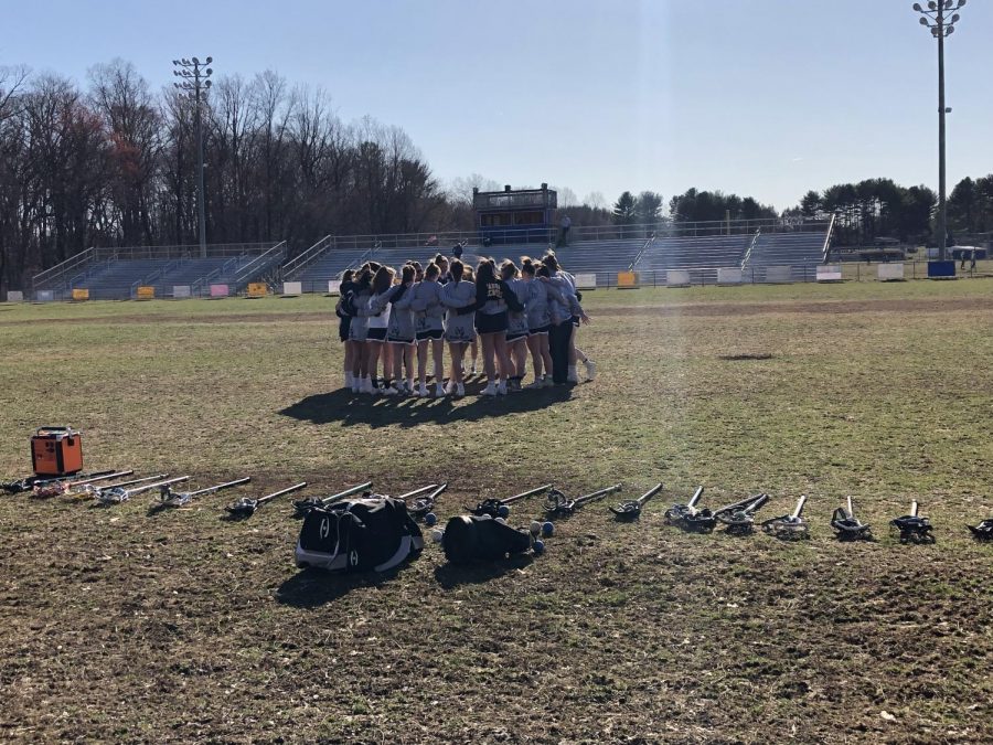 The team prepares for the game and discusses their plan during warm-ups.