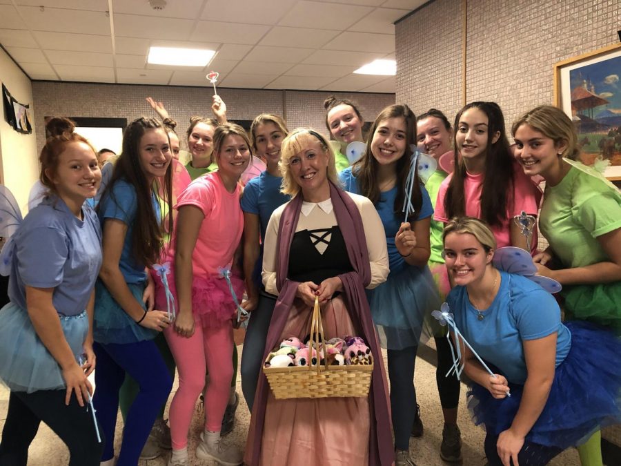 The volleyball team dressed up as characters from the movie, Sleeping Beauty. Mrs. Giaquinto is Sleeping Beauty, and the team members are fairies.
