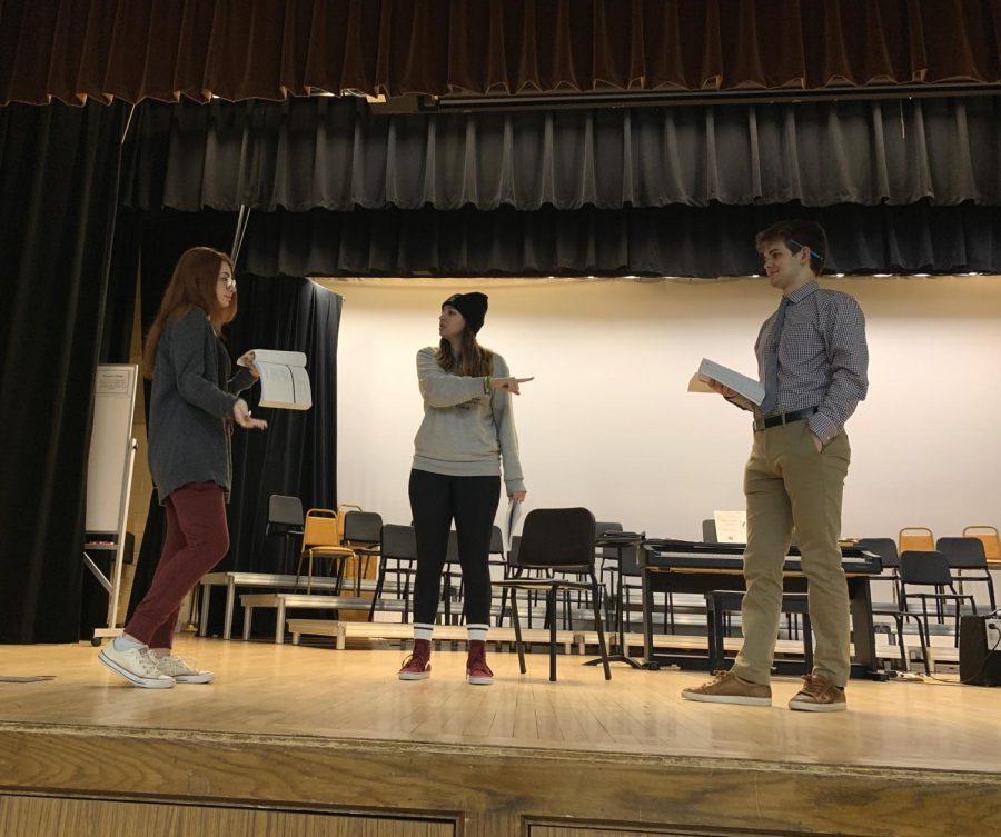 Student producer Caroline Achenbach, director Meg Jullian, and Salesanium student Jack Krukiel adjusting lines during rehearsal. 