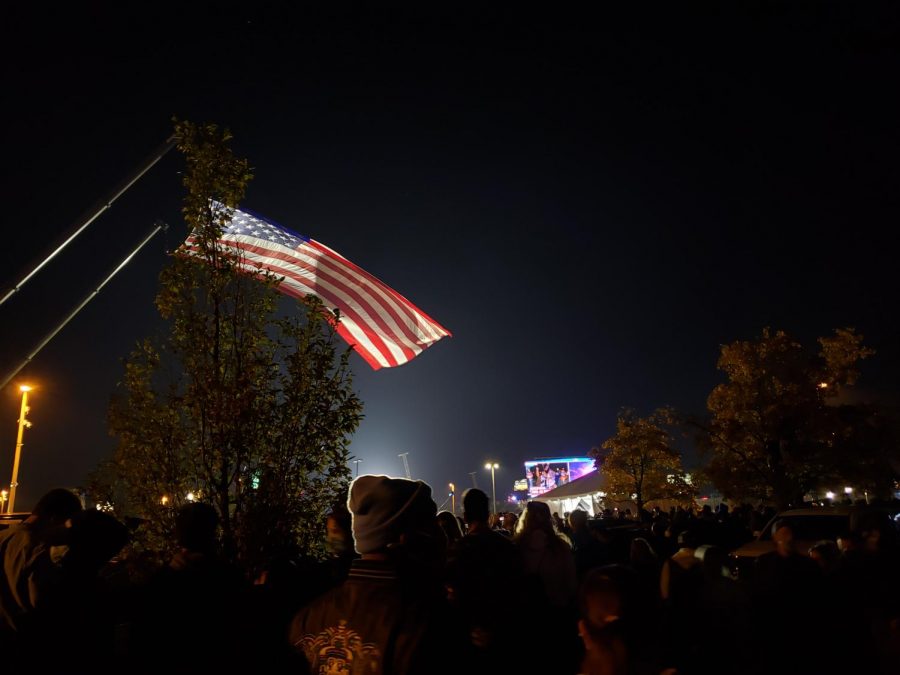 An+American+flag+waves+through+the+air+during+the+Biden-Harris+victory+celebration.+Supporters+flocked+to+the+Riverfront+on+November+7+to+be+part+of+the+historic+night.