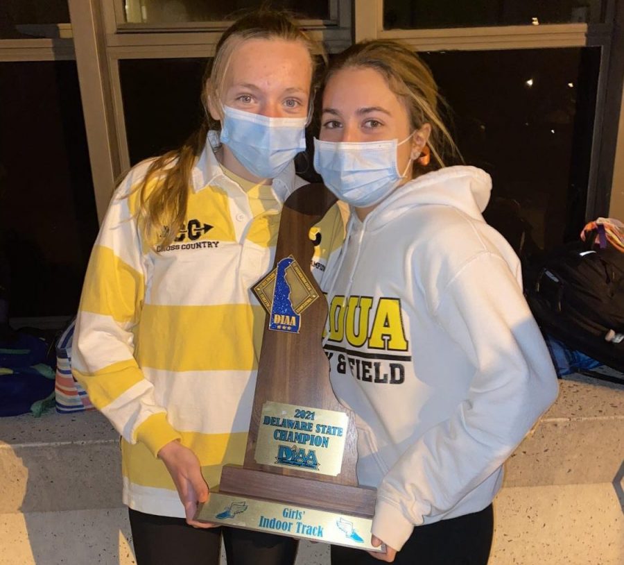 Julia Querey (right) poses with the state title championship trophy.