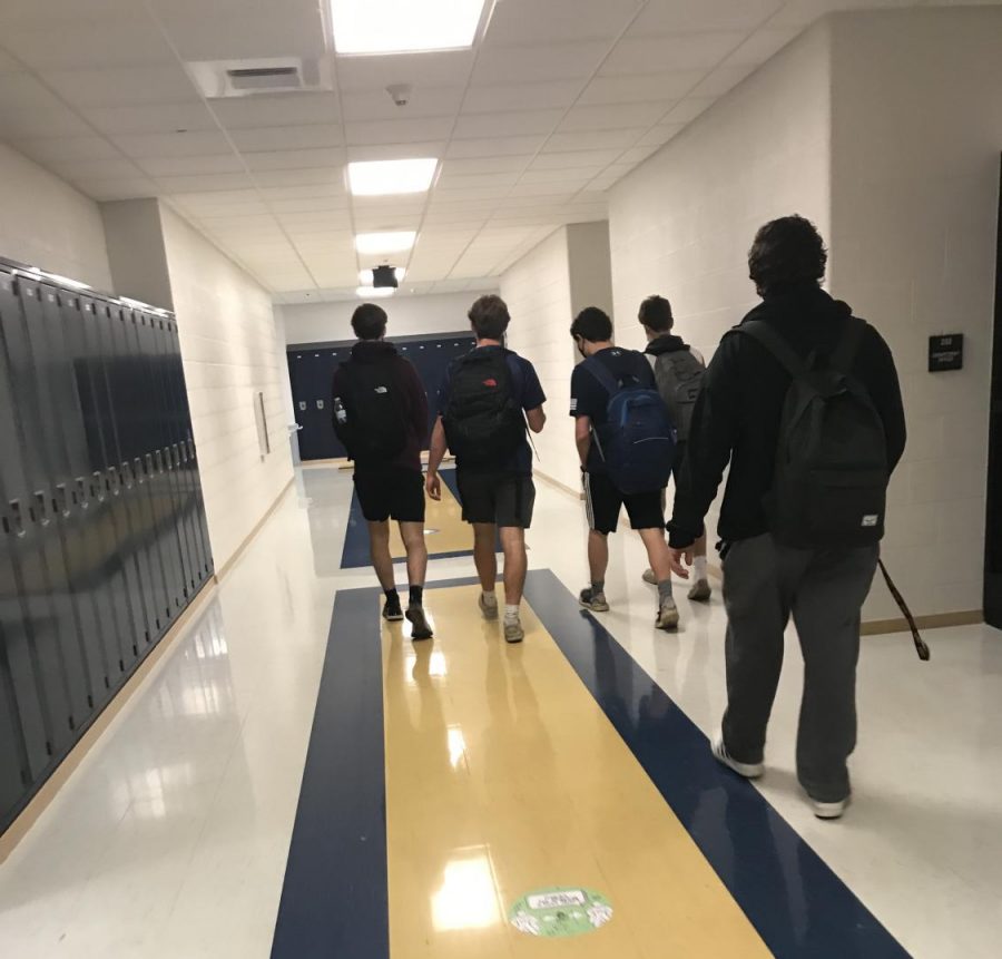 Students walk through Unionville High School as they return to a five-day schedule. Directional hallways are one way the school is reducing the potential of spreading the virus.