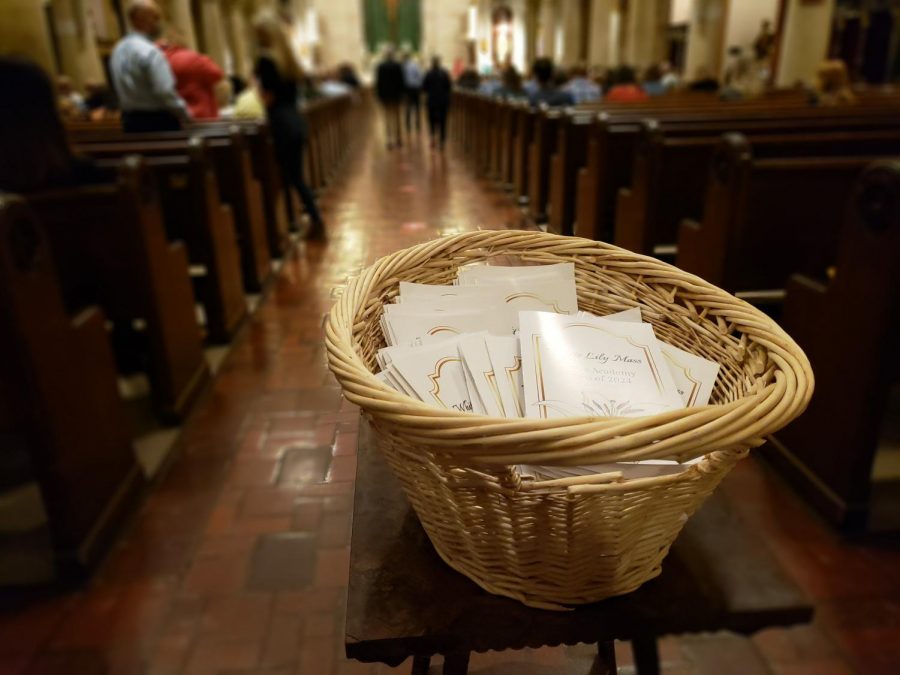 The White Lily Mass booklets sit at the entrance as family members found their seats. Guests waited for their student to process down the center aisle with their fellow sophomores.