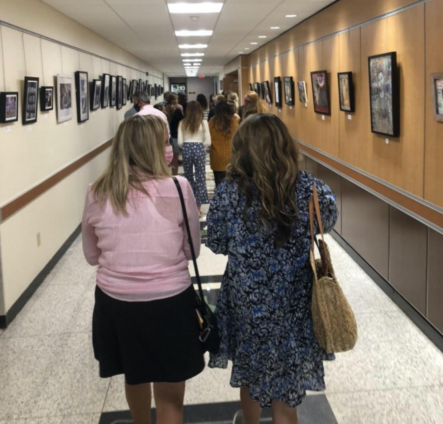Visitors fill the hallways on their way to the next room. Throughout their tour, they had the chance to look at all the buildings features.