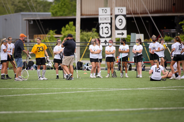 Paduas lacrosse team stands on the sideline of a game this past year. Brendan McCormick was helping out the lacrosse team during their game, and he will be head coach this coming season.