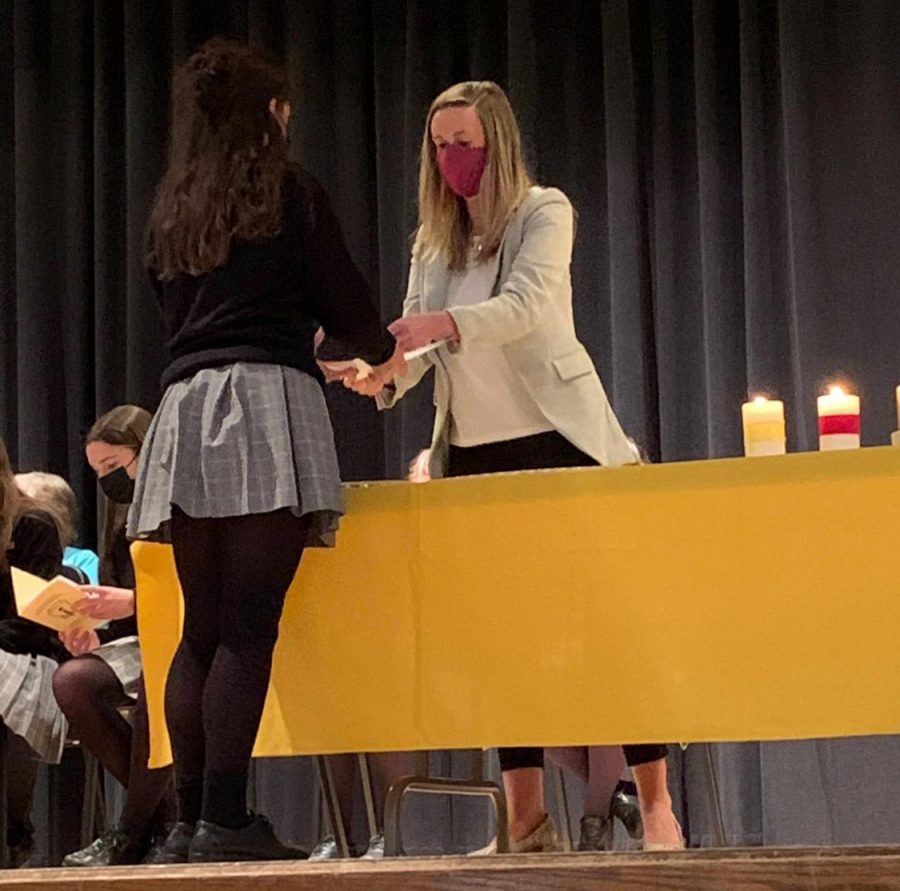 Dr. Crystle installs Rachel Smookler 23 into the National Honor Society. Smookler received a certificate and pin in honor of her achievement.