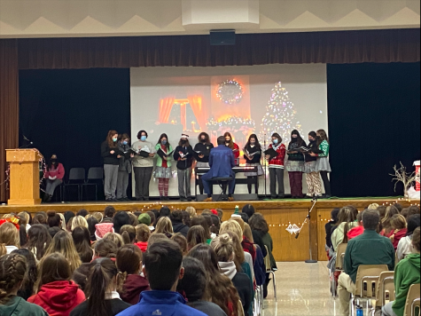 The choir performs at the annual Tree Trim celebration. Their set included Let it Snow, Emmanuel, and The Song in the Air, a holiday madrigal.