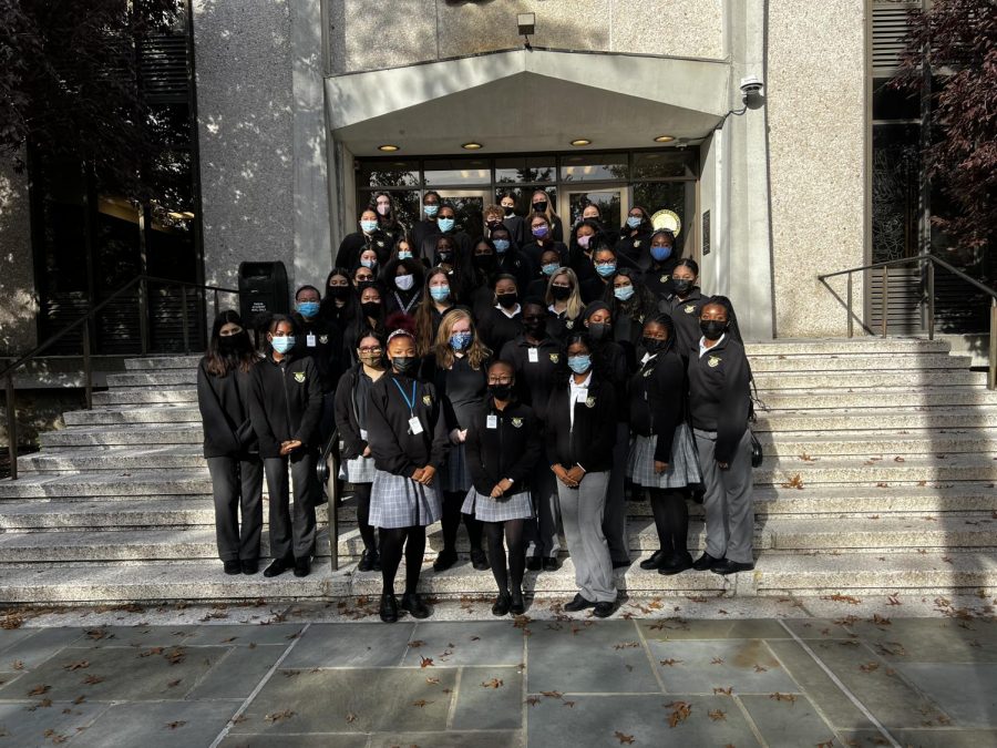 The Alliance poses for a picture on the front steps of the school. The umbrella group was created in September 2021.