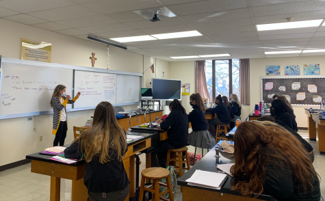 Students copy down notes as Mrs. Judy further explains a biology concept. Judy has spent time in the scientific field, and students said she makes it easier to understand the new information.
