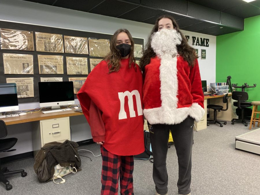 Juniors Sophia Correale and Christina DellOrefice dress in the red costumes of an M n M and Santa Claus in celebration of spirit day. Students of every grade incorporated their class color into various costumes.