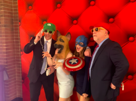 Elce Walsh ‘25 and Madison Keener ‘25 take pictures at the photo booth with their fathers. They wore fun masks and hats, using props to make the picture creative.