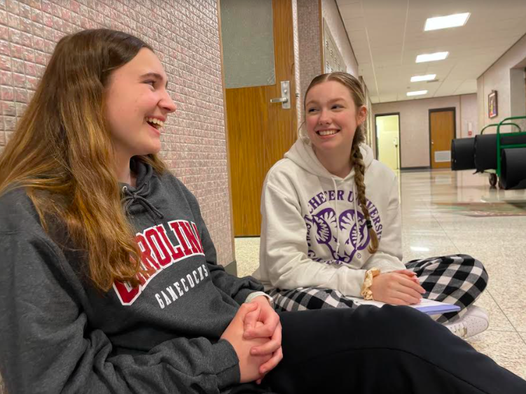 Grace+Stout+and+Amy+Lauderbaugh+discuss+future+college+plans.+Both+seniors+represented+their+school+by+wearing+college+sweatshirts+during+Senior+Spirit+Week.