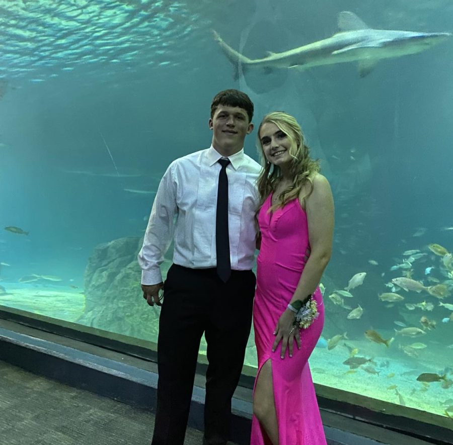 Juniors Shannon Grier and Joe McGrellis pose for a photo in front of a shark at the Adventure Aquarium in Camden, N.J. Concerning her choice to rewear her prom dress, she said, “It’s too expensive and pretty for me just to wear it once.”
